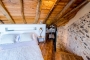 The attic room with low ceilings is a cozy bedroom