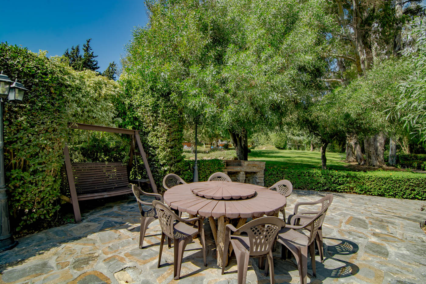 Furnished terrace surrounded by mature gardens