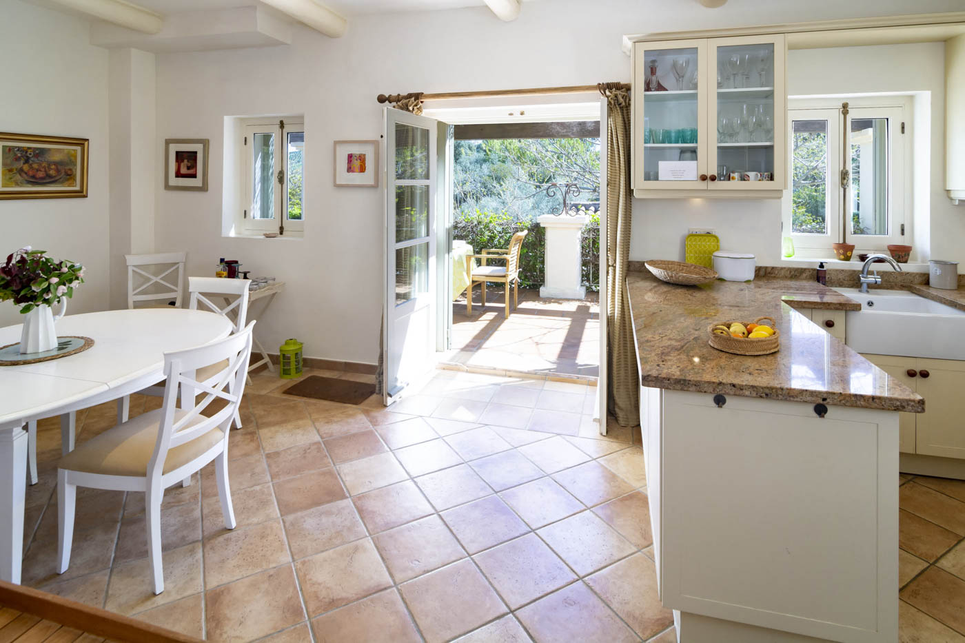 Kitchen / dining area with doors to shaded terrace