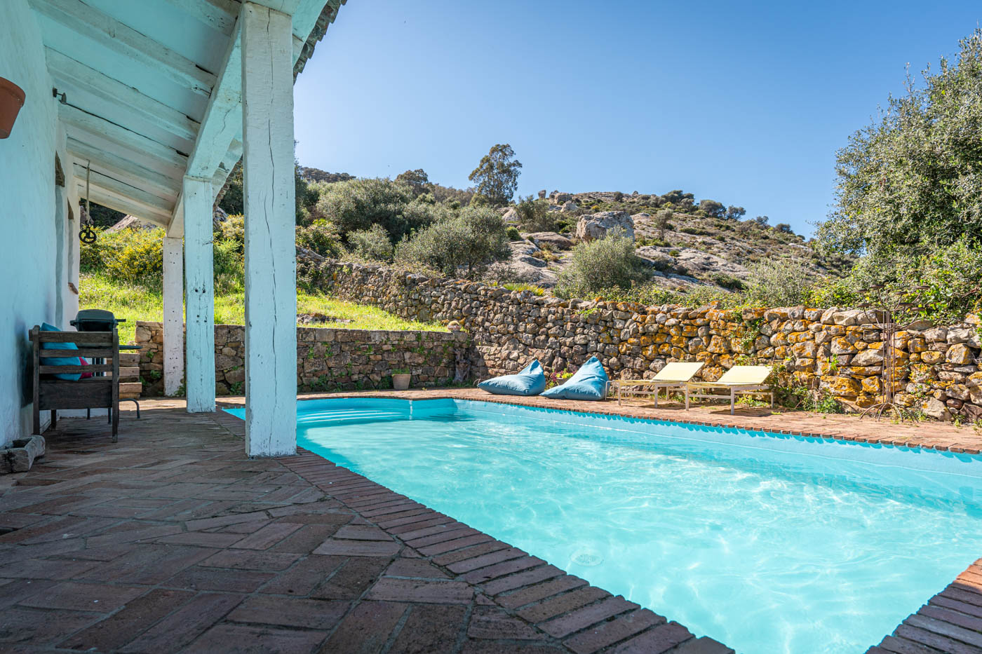 The pool is next to the house