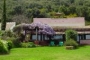 The garden cottage looks across the garden to the sea