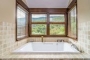 We love this large bath tub with forest views