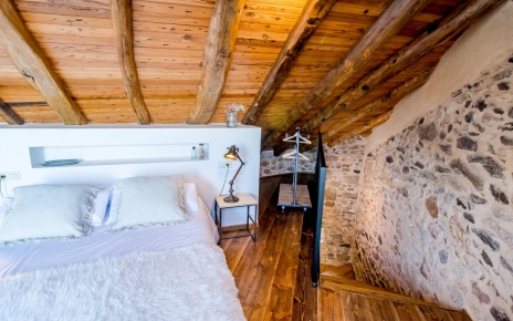 The attic room with low ceilings is a cozy bedroom