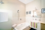 En suite bathroom with bath tub and walk-in shower