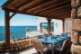 Furnished pergola next to barbecues and kitchen area