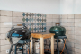 Gas barbecues next to furnished pergola
