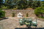 Entrance from parking through stone walled patio