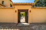 Entrance through pretty walled patio