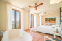 Master bedroom with bathtub and balconies