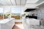 The outdoor dining area has barbecue,fridge,sink