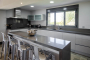 Kitchen with bar and stools