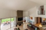 Living area with high ceilings and doors to gardens