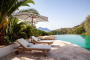 Sunloungers and parasols by the pool 