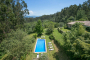 Pool area on a lower terrace with sunloungers