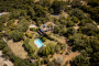 Parking area, villa and gardens seen from the sky