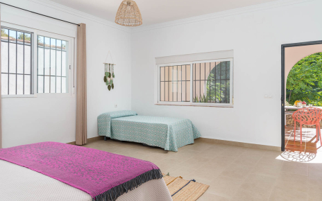 Bedroom 1 with doors to front porch