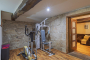 Gym with doors to another sitting room